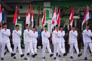 Paskibraka (Indonesian flag raiser) with national flag during grebeg pancasila