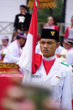 Paskibraka (Indonesian flag raiser) with national flag during grebeg pancasila