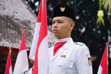 Paskibraka (Indonesian flag raiser) with national flag during grebeg pancasila