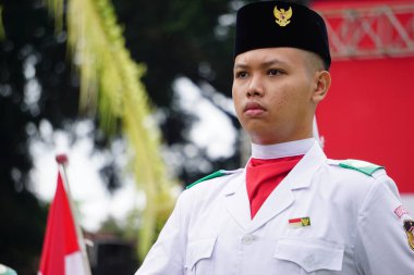 Paskibraka (Indonesian flag raiser) with national flag during grebeg pancasila