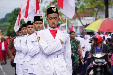 Paskibraka (Indonesian flag raiser) with national flag during grebeg pancasila