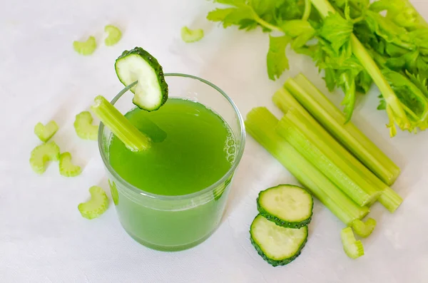 Fresh celery and cucumber juice. Green healthy drink in a glass on a white background. Detox diet, pure organic food, with vegetables. — Stock Photo, Image