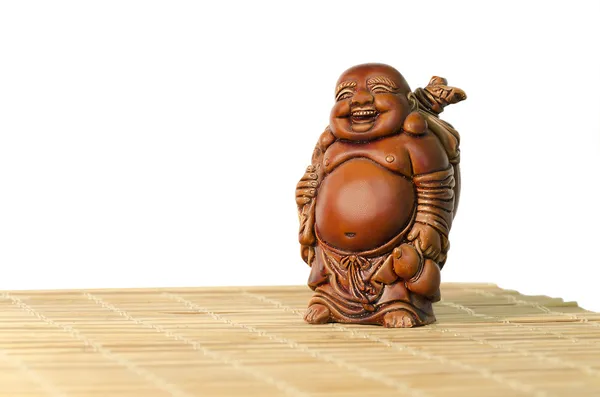 Statuette of laughing Buddha on a white background