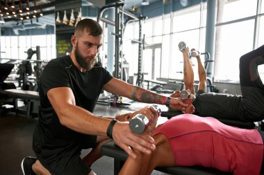 Atletik yakışıklı antrenör ve yaşlı bayan müşteri.