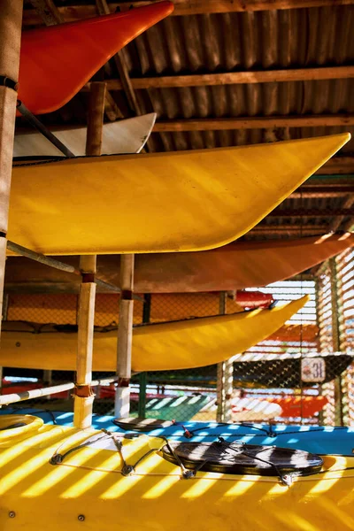 Collection of kayaks on shelves in storage — Stock Photo, Image