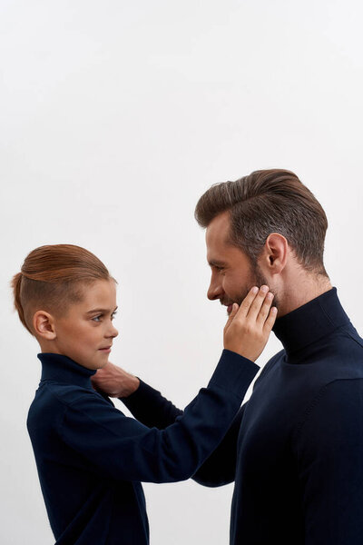 Vertical shot of father and son have tender moment