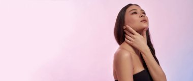 Pembe arka planda güzel bir Asyalı modelin afişi.