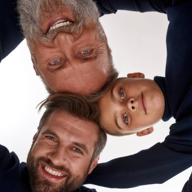 Gülümseyen üç erkek neslin portresi.