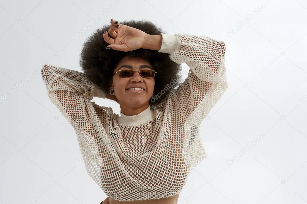 Young smiling black woman posing in glasses