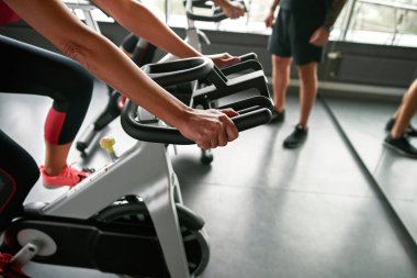 Kadınların ellerinin bisiklet simülatöründe yakın plan görüntüsü