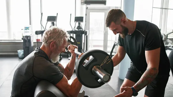 You can do it concept. Trainer cheering man at gym