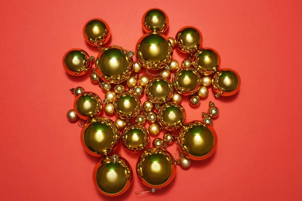 Golden christmas balls isolated on red background — Stock Photo, Image