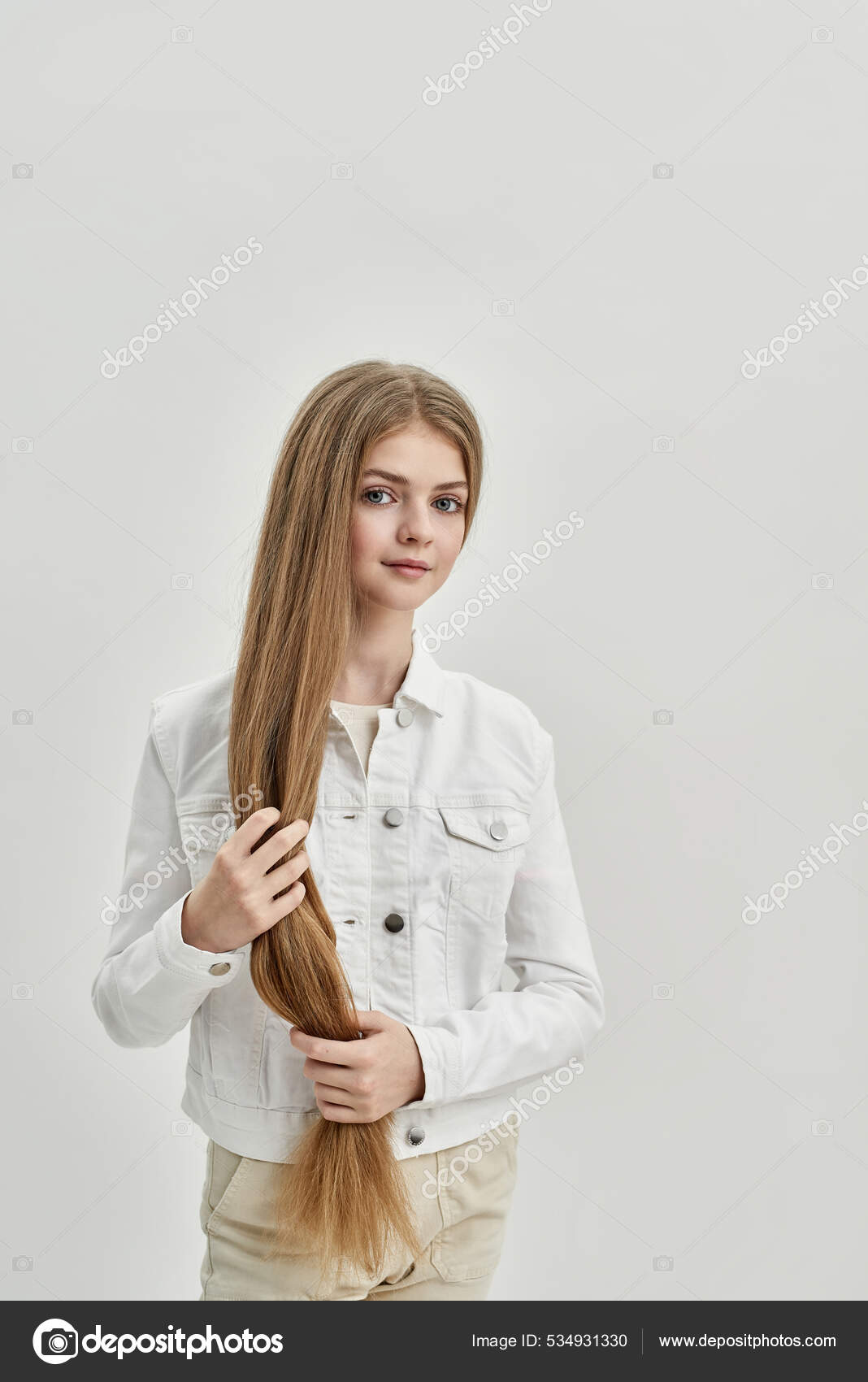 Cute teenage girl with thick long hair. Portrait of Caucasian