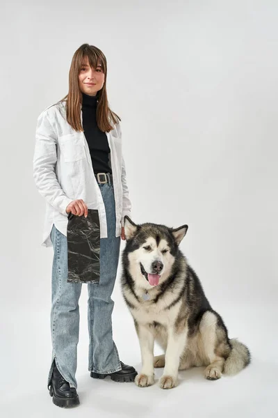 Girl holding dog cleaning package near dog