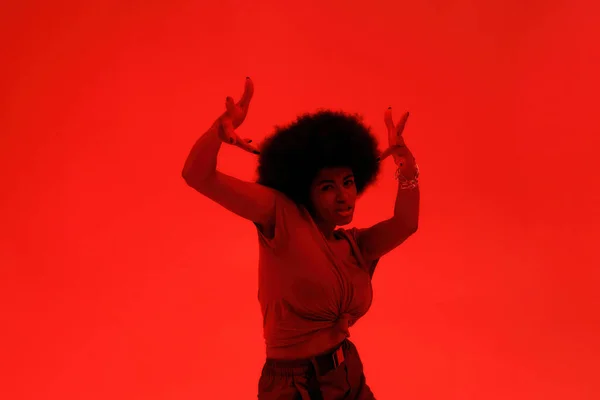 Young black brunette woman dancing hip hop dance