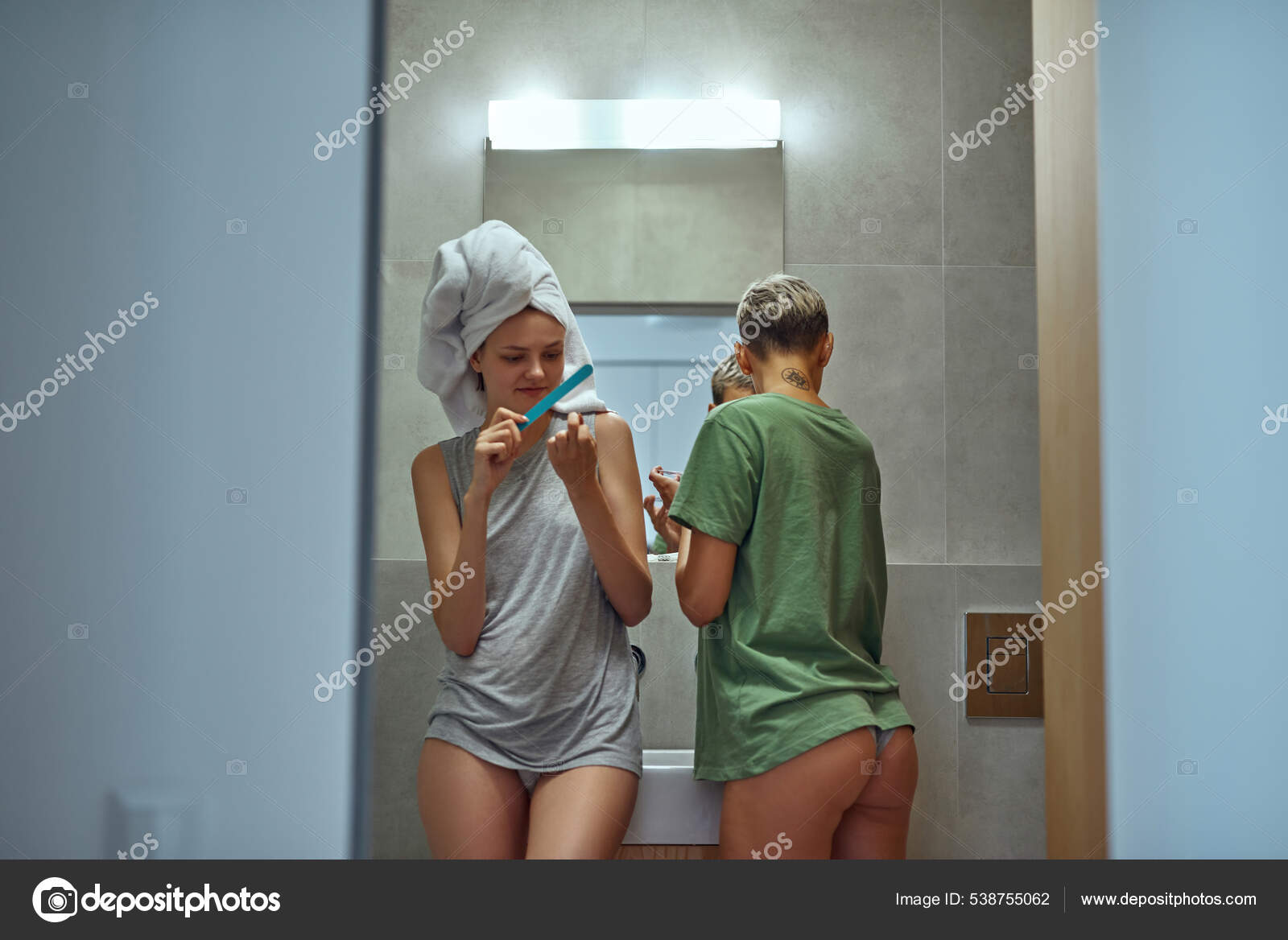 Lesbians do beauty morning procedures at bathroom Stock Photo by ©LanaStock  538755062