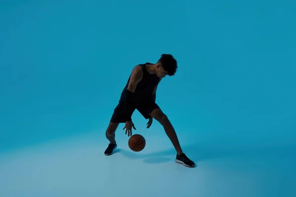 Black sports man dribbling with basketball ball — Stock Fotó