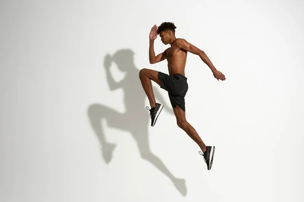 Side view of sportsman jump during sport training