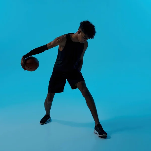 Black male player dribbling with basketball ball — Stock Fotó