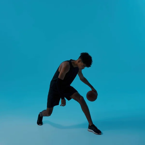 African male player dribbling with basketball ball — Stock Fotó