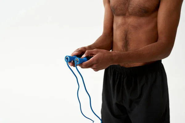 Cropped of black sportsman holding skipping rope — Stock Photo, Image