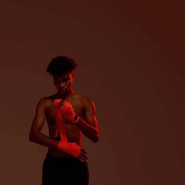 stock image Black male boxer wrapping elastic bandage on hand