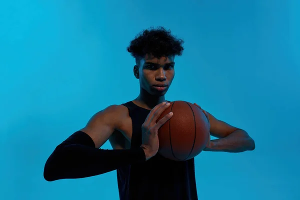 Ember tartsa kosárlabda és nézz a kamerába — Stock Fotó