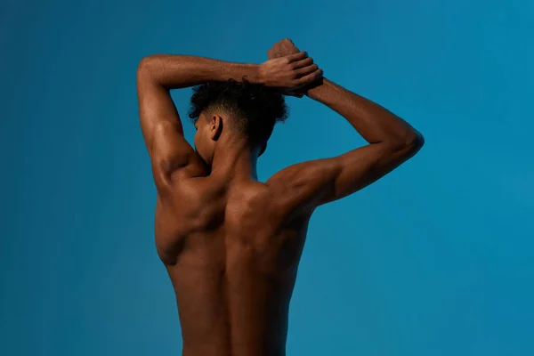 Back of black sportsman stretching before training — Stock Photo, Image