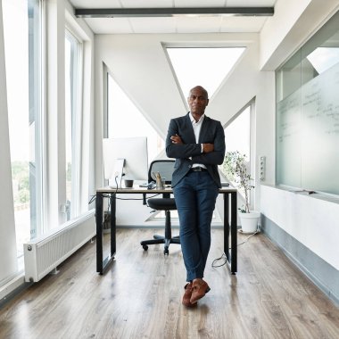 Serious black male businessman with crossed arms