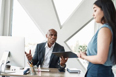 Disappointed black boss look at female employee