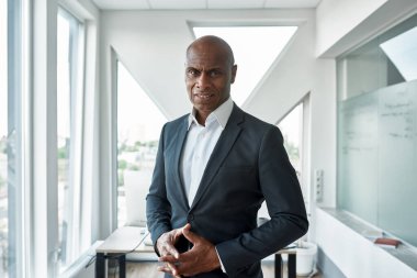 Male businessman look at camera in spacious office