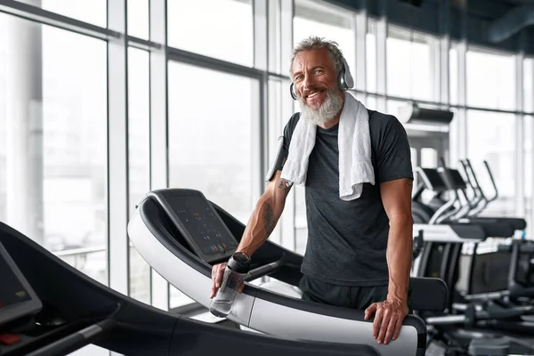 Tired but happy mature sportsman in gym — Foto Stock