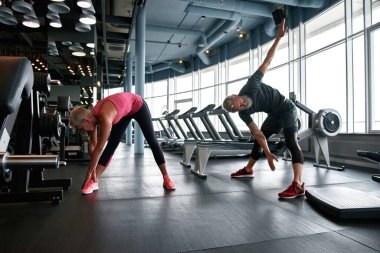 Short warm-up before main workout performed by mature couple