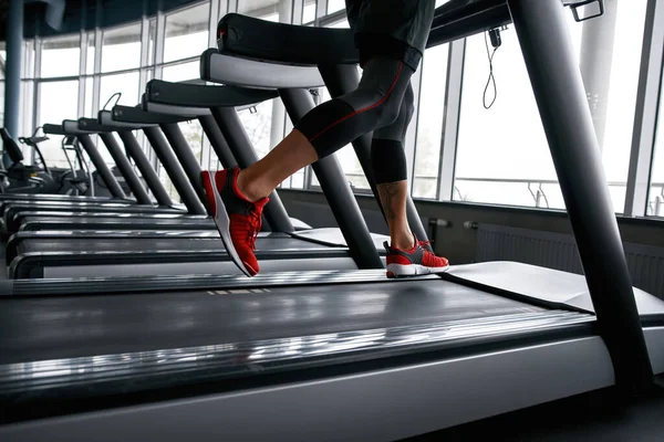 Male legs while jogging on treadmill, closeup — Fotografia de Stock