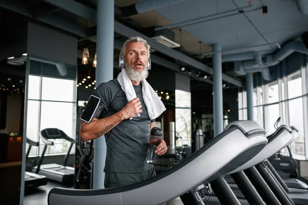 Exhausted mature man after working out in sports center — Foto Stock