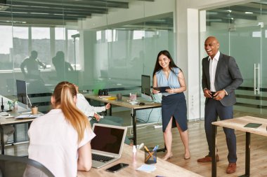 Leader and employees laughing at business meeting