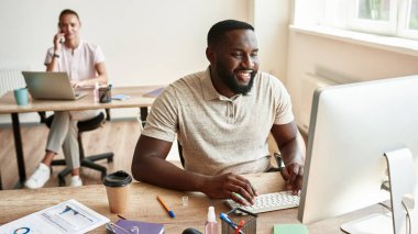 Black man watch on computer monitor while work