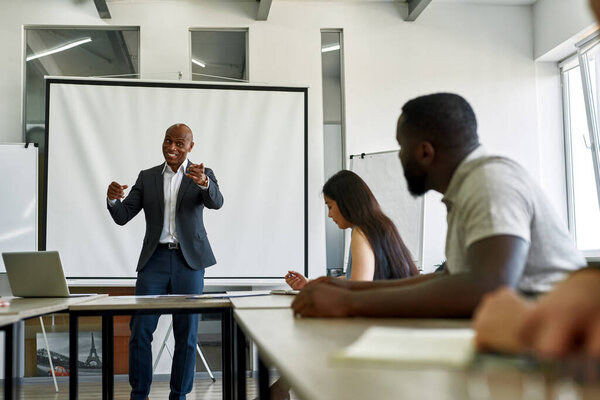 Boss point with finger at employee during meeting
