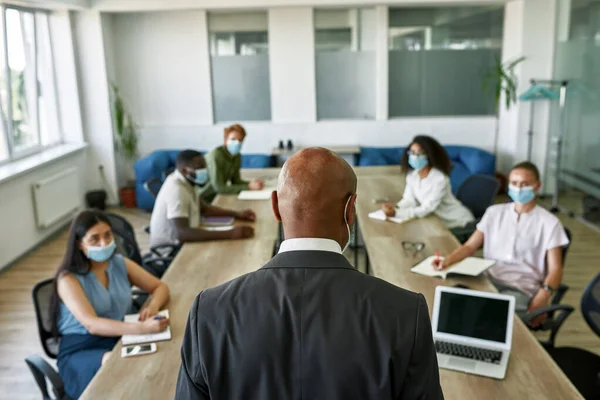 Back view of boss tell to employees at meeting —  Fotos de Stock