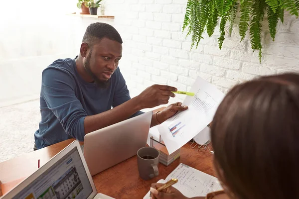 Mann zeigt Mädchen während der Arbeit Geschäftsdiagramm — Stockfoto