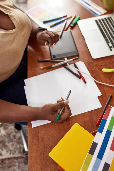 Female designer drawing on paper and using laptop — Stock Photo, Image