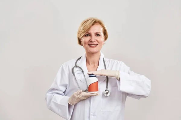 Καυκάσια γυναίκα γιατρός με χάπια ματιά στην κάμερα — Φωτογραφία Αρχείου
