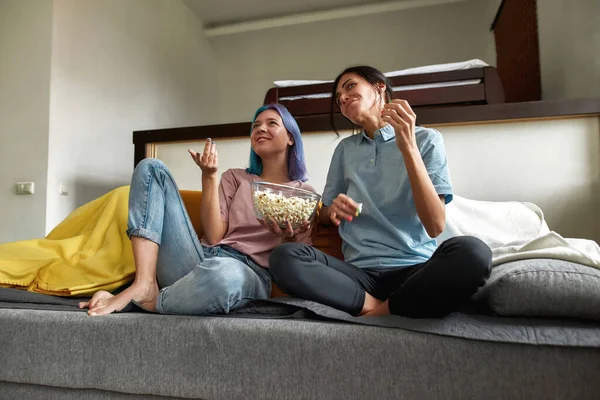 Cheeful coppia lesbica guardando commedia seduta sul divano — Foto Stock
