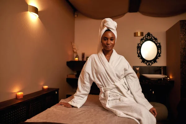 Black girl on massage table and looking at camera — Stock Photo, Image