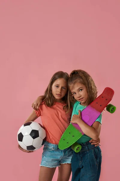 Kislányok labdáznak, gördeszkáznak és ölelkeznek. — Stock Fotó