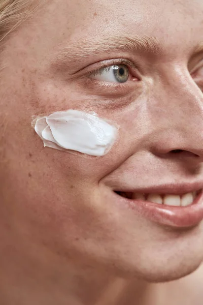 Close up of guy with cosmetic cream on his face — Stock Photo, Image