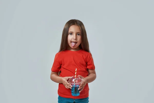 Little girl licking lips after drinking soda drink — Stock Photo, Image