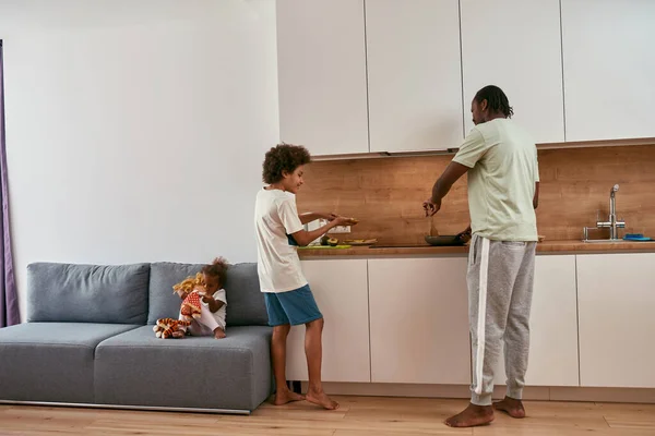 Costas de pai e filho cozinhar café da manhã em casa — Fotografia de Stock