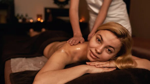 Massagista feminina fazer massagem nas costas de mulher relaxante — Fotografia de Stock