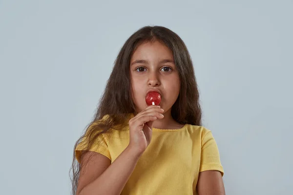 Partial image of little girl licking lollipop — Stock Photo, Image